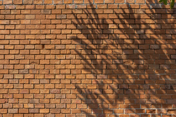 Poster - A brick wall with a shadow cast on it