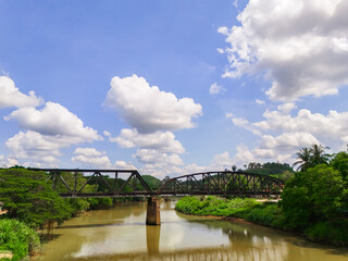 aerial view Railway tracks in the suburbs. The railway line crosses the river. The bridge connects the railway line with the river and nature. Train transportation 