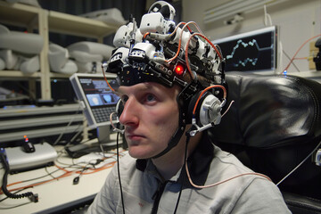 Testing brain-computer interface, monitoring neural signals for innovative technology advancement in lab.