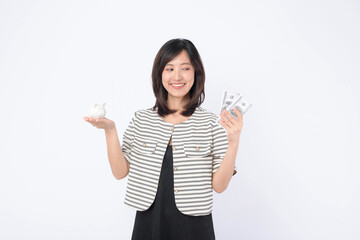 Poster - young beautiful business asian woman with a lot of cash money and piggy bank isolated on white background. Wealth money saving, finance investment concept.