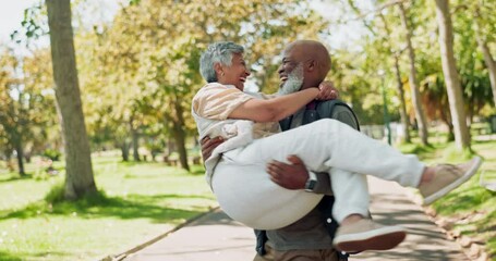 Canvas Print - Happy, interracial and senior couple with love in park for romance, support or care in nature. Man carrying woman with smile for romantic date or playing in forest, woods or outdoor celebration