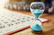 © HASAN - Picture a mesmerizing juxtaposition: an hourglass depicted with minimalist finesse, juxtaposed against the ordered framework of a calendar, underscoring the urgency of time managem