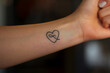 © Nati - A heart outline with an infinity symbol on the wrist.