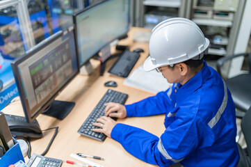 engineer working at control room,manager control system,technician man monitoring program from a lot