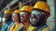 © Pavel - A group of smiling construction workers with yellow helmets and reflective vests, laughing while standing