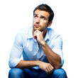 © OKAN - Thoughtful Man Sitting and Looking Up in Studio Lighting Midday
