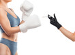 © Dimid - A young beautiful girl in blue underwear and white boxing gloves. The cosmetologist holds a syringe for injection.