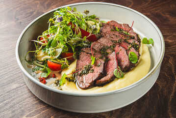 Sticker - Sliced beef with herbs, served alongside puree and a side salad.