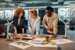 © Zamrznuti tonovi - Diverse team working on sustainable and renewable energy at office.