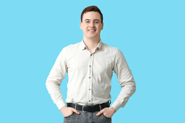 Wall Mural - Happy young man in stylish collar shirt on blue background