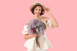 © Pixel-Shot - Beautiful young woman with bouquet of blooming lilac flowers on pink background