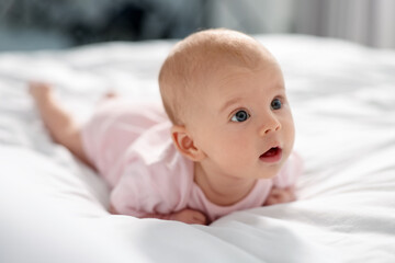 Sticker - Cute little baby lying on white sheets