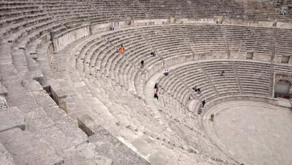 Wall Mural - Roman Theater, Roman ruins, people walk through the amphitheater