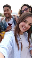 Wall Mural - Vertical HD video of uoung group of happy people drinking red wine enjoying rooftop summer party together. Cheerful multiracial young friends dancing together while celebrating at home terrace.