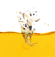 Wall Mural - Sunflower seeds falling into cooking oil on white background