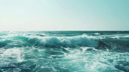 Wall Mural - the concept of World Ocean Day. Beautiful nature landscape. World Water Day. A vast ocean with waves, turquoise water, and a clear sky in the distance. 