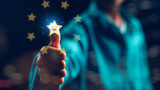 Fototapeta  - A person is holding a star and giving it a thumbs up