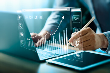 businessman using laptop and analyzing economic growth, financial graph and business investment. pla