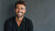 © Mutshino_Artwork - Smiling young man in casual black shirt against dark background