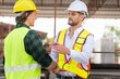© Poguz.P - Engineer and foreman worker team inspect the construction site, Site manager and builder team meeting for planning project at construction site