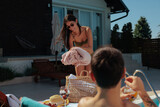 Fototapeta  - Husband and wife relaxing by their summerhouse pool