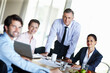© peopleimages.com - Happy, business people or team with laptop in office for meeting, discussion and deal negotiation. Corporate, colleagues or employees smiling in boardroom together for contract, review and feedback