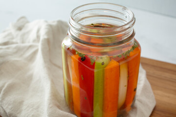 Wall Mural - A view of vegetable sticks pickling inside a mason jar.