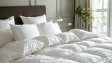 Fototapeta  - A bed with white pillows and white flowers on it.

