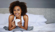 © peopleimages.com - Smile, bed and portrait of woman with coffee for weekend, happiness and beverage in morning. Apartment, relax and female person with warm drink in hotel for hospitality, peace and comfort of duvet