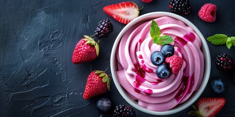 Wall Mural - fruit ice cream with raspberries, strawberries and blackberries on dark slate background