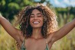 © duyina1990 - carefree black woman with arms outstretched in a field