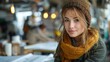 © andriyyavor - Young Woman in a Cozy Café Setting Wearing Winter Attire
