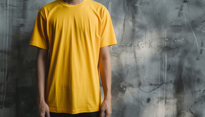 Wall Mural - Yellow T-Shirt Worn by Person Against Grunge Background for Style, Shirt Mocup