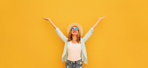 Wall Mural - Summer holidays, inspired happy smiling young woman raising hands up on colorful yellow background