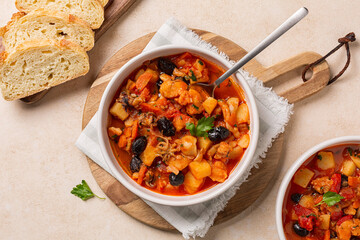 Poster - Top view of fish stew, made with anglerfish, seppia, tomato, olives and potato.