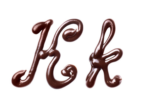 Large and small Letter K of the Latin alphabet made of melted chocolate, isolated on a white background