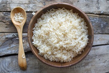 Poster - Cooked white rice in a bowl next to a wooden spoon on a wooden table. Generative AI