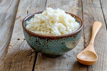 Poster - A bowl of white rice and a wooden spoon placed on a wooden table. Generative AI