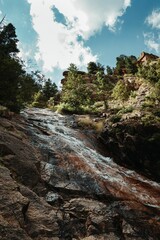 Wall Mural - Picturesque scene of a waterfall in Colorado Springs, Colorado against a blue clouded sky