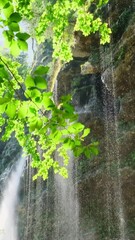 Wall Mural - Beautiful view of the Pericnik waterfall in Triglav National Park, Slovenia. Slow motion tracking shot. Magnificent Pericnik waterfall in beautiful green forest at sunny day.