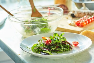 Wall Mural - Salad of greens and fried garlic, cherry tomatoes and Chorizo sausage. The cooking process, step-by-step recipe