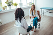 © Dragana Gordic - Woman In Consultation With Female Doctor Sitting On Examination Couch In Office. Cropped shot of an attractive young female doctor consulting with a patient inside her office at a hospital