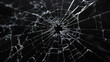© Santy Hong - Abstract pattern of spider-web cracks emanating from a central hole in a pane of glass, showcased against a deep black backdrop.