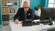 © Krakenimages.com - Young hispanic man business worker using touchpad taking notes at the office