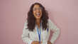 © Krakenimages.com - A joyful middle-aged woman in a white lab coat and clear glasses laughs heartily against a pink background.