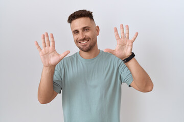 Poster - Hispanic man with beard standing over white background showing and pointing up with fingers number ten while smiling confident and happy.