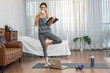 © Art_Photo - Portrait sport asian beauty body slim woman in sportswear standing relax and practicing yoga do fitness exercise drink coffee and read book in bedroom at home.Diet concept.Fitness and healthy