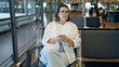 © Krakenimages.com - Beautiful young hispanic woman using smartphone at the airport