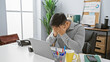 © Krakenimages.com - A distressed asian man in a modern office holds his head in evident frustration or exhaustion.