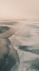 Wall Mural - Dunes and ocean waves merging near the sea in an aerial view